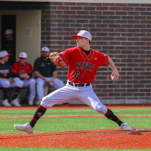 Raven's pitcher winding up to throw a pitch