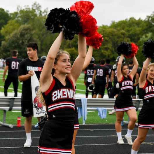 Cheerleaders cheering at a football game