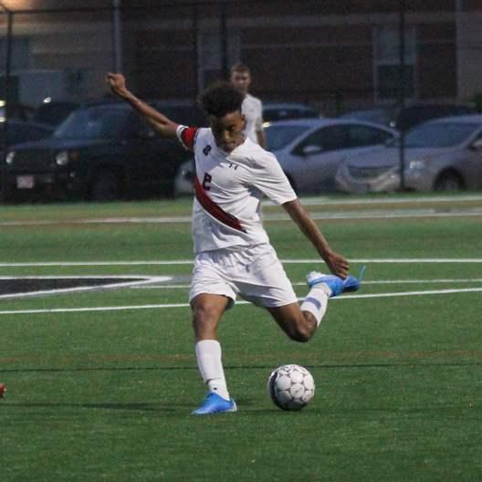 Men's Soccer player gearing up to kick the ball