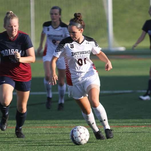 Benedictine College Women's Soccer player pushing the ball down the field