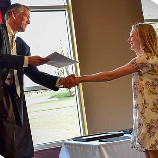 Head of the department giving a student an award